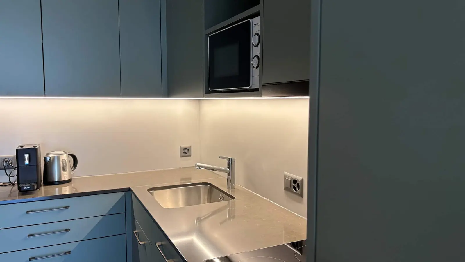 Küche mit Mikrowelle und Backofen